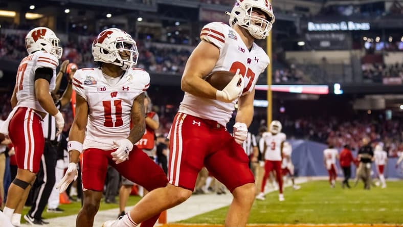 Dec 27, 2022; Phoenix, Arizona, USA; Wisconsin Badgers tight end Hayden Rucci (87) celebrates a touchdown with wide receiver Skyler Bell (11) against the Oklahoma State Cowboys in the first half of the 2022 Guaranteed Rate Bowl at Chase Field. Mandatory Credit: Mark J. Rebilas-USA TODAY Sports