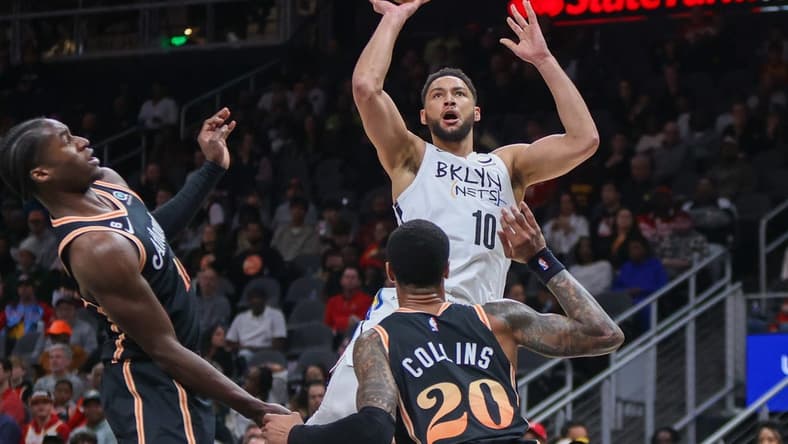 Dec 28, 2022; Atlanta, Georgia, USA; Brooklyn Nets guard Ben Simmons (10) shoots over Atlanta Hawks forward John Collins (20) in the first quarter at State Farm Arena. Mandatory Credit: Brett Davis-USA TODAY Sports