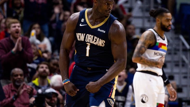 Dec 28, 2022; New Orleans, Louisiana, USA; New Orleans Pelicans forward Zion Williamson (1) reacts to making a basket against Minnesota Timberwolves guard D'Angelo Russell (0) during the second half at Smoothie King Center. Mandatory Credit: Stephen Lew-USA TODAY Sports