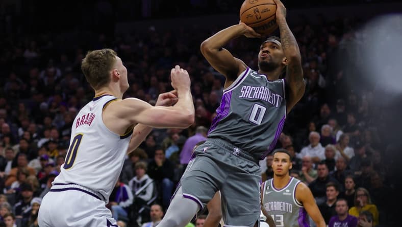 Dec 28, 2022; Sacramento, California, USA; Sacramento Kings guard Malik Monk (0) shoots the ball over Denver Nuggets guard Christian Braun (0) during the third quarter at Golden 1 Center. Mandatory Credit: Sergio Estrada-USA TODAY Sports