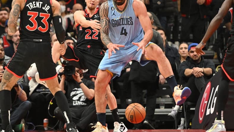 Dec 29, 2022; Toronto, Ontario, CAN; Memphis Grizzlies center Steven Adams (4) grabs a rebound in front of Toronto Raptors guard Malachi Flynn (22) in the first half at Scotiabank Arena. Mandatory Credit: Dan Hamilton-USA TODAY Sports