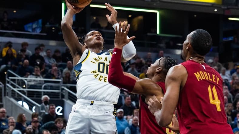 Dec 29, 2022; Indianapolis, Indiana, USA; Indiana Pacers guard Bennedict Mathurin (00) shoots the ball while Cleveland Cavaliers forward Isaac Okoro (35) defends at Gainbridge Fieldhouse. Mandatory Credit: Trevor Ruszkowski-USA TODAY Sports