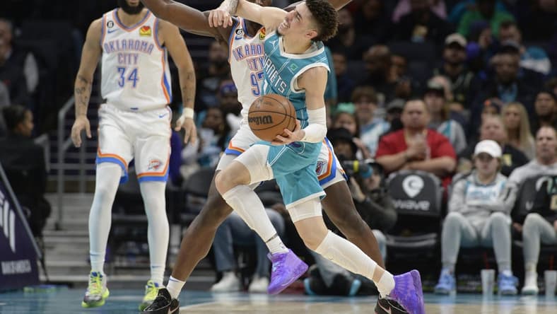 Dec 29, 2022; Charlotte, North Carolina, USA; Charlotte Hornets guard LaMelo Ball (1) is fouled by Oklahoma City Thunder forward Eugene Omoruyi (2) during the first half at the Spectrum Center. Mandatory Credit: Sam Sharpe-USA TODAY Sports