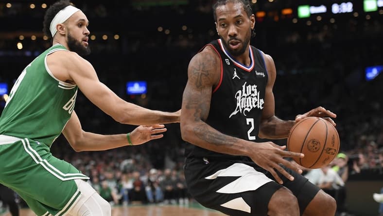 Dec 29, 2022; Boston, Massachusetts, USA; LA Clippers forward Kawhi Leonard (2) controls the ball while Boston Celtics guard Derrick White (9) defends during the first half at TD Garden. Mandatory Credit: Bob DeChiara-USA TODAY Sports