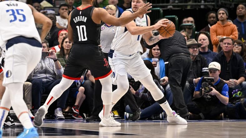 Dec 29, 2022; Dallas, Texas, USA; Dallas Mavericks guard Luka Doncic (77) looks to pass around Houston Rockets guard Eric Gordon (10) during the first quarter at the American Airlines Center. Mandatory Credit: Jerome Miron-USA TODAY Sports