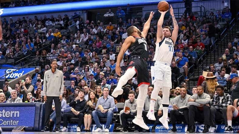 Dec 29, 2022; Dallas, Texas, USA; Dallas Mavericks guard Luka Doncic (77) shoots over Houston Rockets guard Eric Gordon (10) during the second half at the American Airlines Center. Mandatory Credit: Jerome Miron-USA TODAY Sports