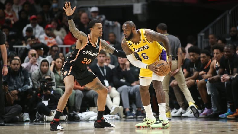 Dec 30, 2022; Atlanta, Georgia, USA; Atlanta Hawks forward John Collins (20) defends Los Angeles Lakers forward LeBron James (6) in the second quarter at State Farm Arena. Mandatory Credit: Brett Davis-USA TODAY Sports