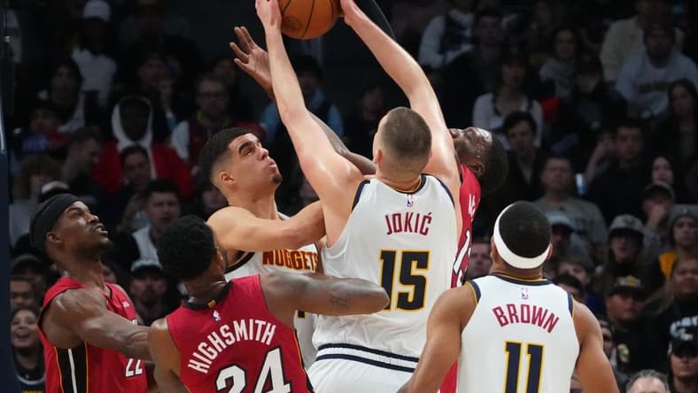 Dec 30, 2022; Denver, Colorado, USA; Miami Heat forward Jimmy Butler (22) and forward Haywood Highsmith (24) and center Bam Adebayo (13) and Denver Nuggets center Nikola Jokic (15) and forward Bruce Brown (11) reach for a rebound in the first quarter at Ball Arena. Mandatory Credit: Ron Chenoy-USA TODAY Sports