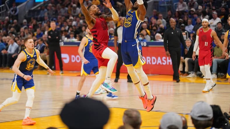 Dec 30, 2022; San Francisco, California, USA; Portland Trail Blazers guard Damian Lillard (0) makes a layup next to Golden State Warriors forward Jonathan Kuminga (00) in the second quarter at the Chase Center. Mandatory Credit: Cary Edmondson-USA TODAY Sports