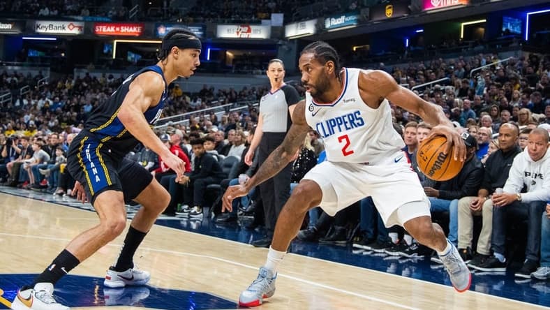 Dec 31, 2022; Indianapolis, Indiana, USA; LA Clippers forward Kawhi Leonard (2) dribbles the ball while Indiana Pacers guard Andrew Nembhard (2) defends in the first quarter at Gainbridge Fieldhouse. Mandatory Credit: Trevor Ruszkowski-USA TODAY Sports