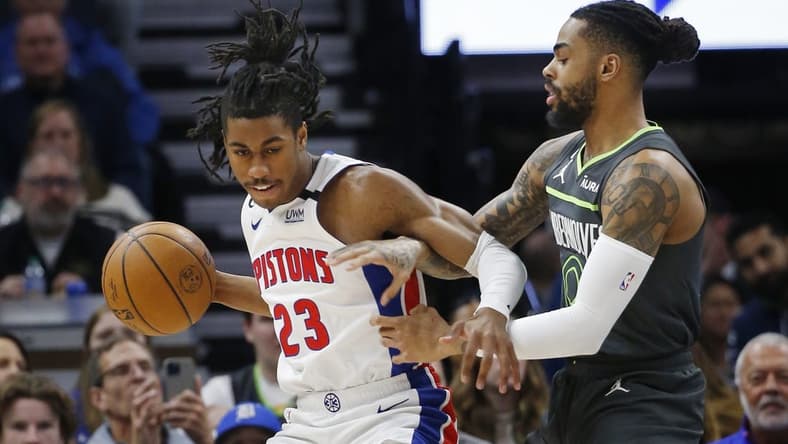 Dec 31, 2022; Minneapolis, Minnesota, USA; Detroit Pistons guard Jaden Ivey (23) works around Minnesota Timberwolves guard D'Angelo Russell (0) in the first quarter at Target Center. Mandatory Credit: Bruce Kluckhohn-USA TODAY Sports