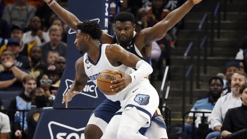 Dec 31, 2022; Memphis, Tennessee, USA; Memphis Grizzlies forward Jaren Jackson Jr. (13) controls the ball against New Orleans Pelicans forward Zion Williamson (1) during the first half at FedExForum. Mandatory Credit: Petre Thomas-USA TODAY Sports