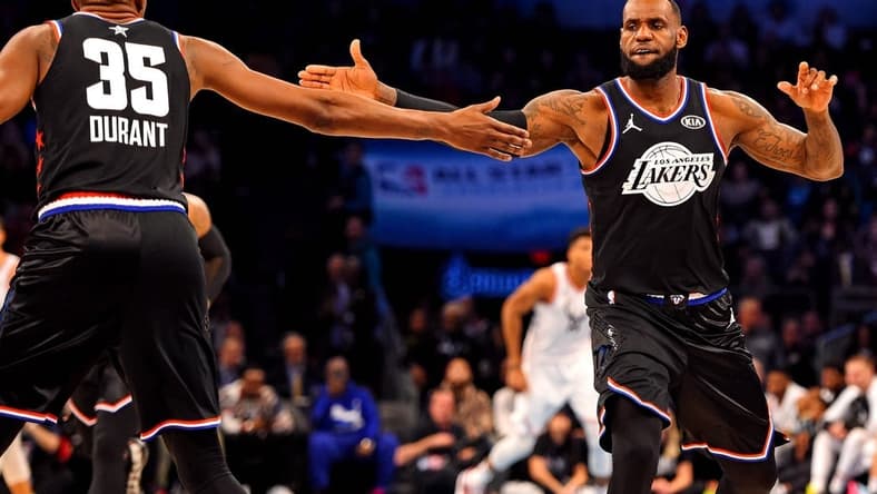 Feb 17, 2019; Charlotte, NC, USA; Team Lebron forward Lebron James of the Los Angeles Lakers (23) reacts with Team Lebron forward Kevin Durant of the Golden State Warrior (35) during the 2019 NBA All-Star Game at Spectrum Center. Mandatory Credit: Bob Donnan-USA TODAY Sports