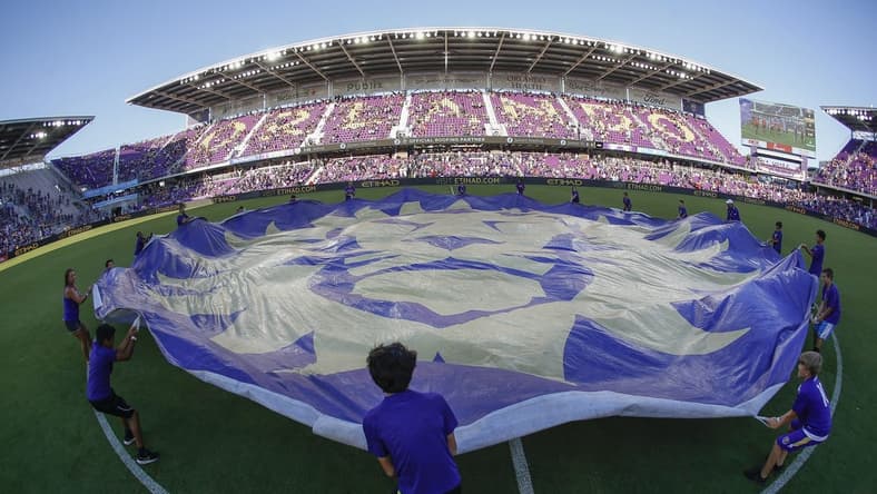 May 24, 2019; Orlando, FL, USA; Orlando City SC fan kids wave the team logo banner at mid field before a match against the Los Angeles Galaxy  at Orlando City Stadium. Mandatory Credit: Reinhold Matay-USA TODAY Sports