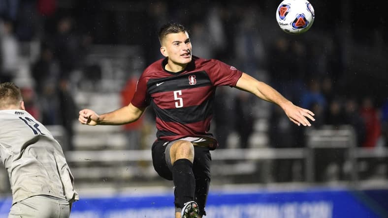 Dec 13, 2019; Cary, NC, USA; Stanford Cardinal defender Keegan Hughes (5) heads the ball in the second half at WakeMed Soccer Park. Mandatory Credit: Bob Donnan-USA TODAY Sports