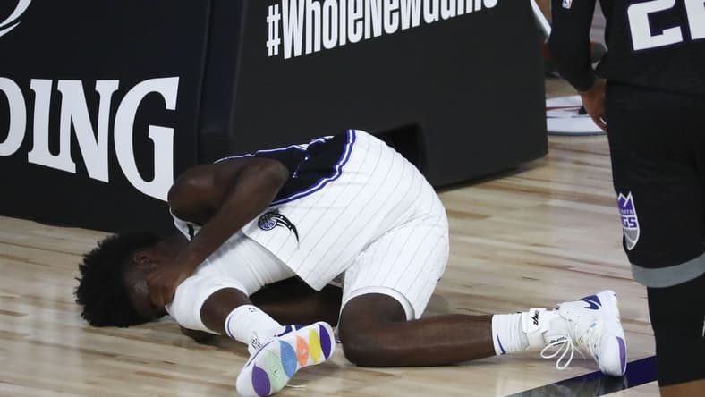 Aug 2, 2020; Lake Buena Vista, Florida, USA; Orlando Magic forward Jonathan Isaac (1) reacts after an injury against the Sacramento Kings in the second half of a NBA basketball game at HP Field House. Mandatory Credit: Kim Klement-USA TODAY Sports