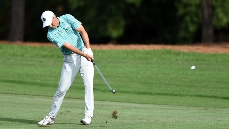 Aug 14, 2020; Greensboro, North Carolina, USA; Jordan Speith hits his approach shot on the eighteenth hole during the second round of the Wyndham Championship golf tournament at Sedgefield Country Club. Mandatory Credit: Rob Kinnan-USA TODAY Sports