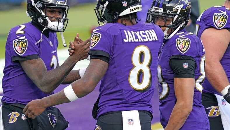 Dec 20, 2020; Baltimore, Maryland, USA; Baltimore Ravens quarterback Lamar Jackson (8) greets quarterback Tyler Huntley (2) prior to a game against the Jacksonville Jaguars at M&T Bank Stadium. Mandatory Credit: Mitch Stringer-USA TODAY Sports
