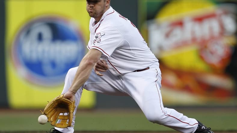 AUGUST 17, 2012: Cincinnati Reds third baseman Scott Rolen (27) makes the grab and the throw to first for the out in the third inning against the Chicago Cubs.
Reds