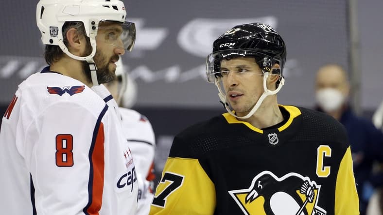 Feb 14, 2021; Pittsburgh, Pennsylvania, USA; Washington Capitals left wing Alex Ovechkin (8) and Pittsburgh Penguins center Sidney Crosby (87) talk before a face-off during the second period at PPG Paints Arena. Mandatory Credit: Charles LeClaire-USA TODAY Sports