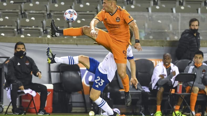 Apr 16, 2021; Houston, Texas, USA;  Houston Dynamo forward Christian Ramirez (9) and San Jose Earthquakes defender Florian Jungwirth (23) volley the ball during the second half at BBVA Stadium. Mandatory Credit: Maria Lysaker-USA TODAY Sports