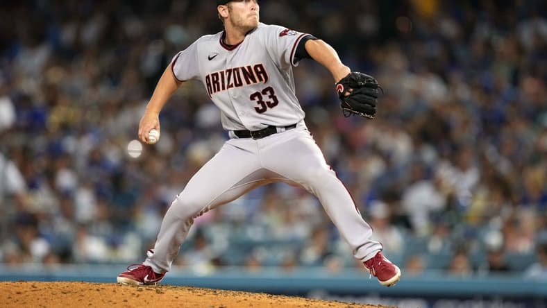 Jul 9, 2021; Los Angeles, California, USA; Arizona Diamondbacks starting pitcher J.B. Bukauskas (33) delivers a pitch against the Los Angeles Dodgers at Dodger Stadium. Mandatory Credit: Kirby Lee-USA TODAY Sports