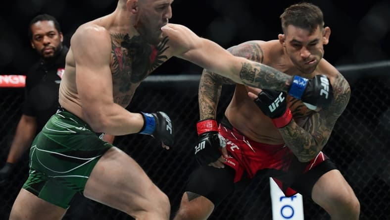 Jul 10, 2021; Las Vegas, Nevada, USA; Conor McGregor moves in for a hit against Dustin Poirier during UFC 264 at T-Mobile Arena. Mandatory Credit: Gary A. Vasquez-USA TODAY Sports