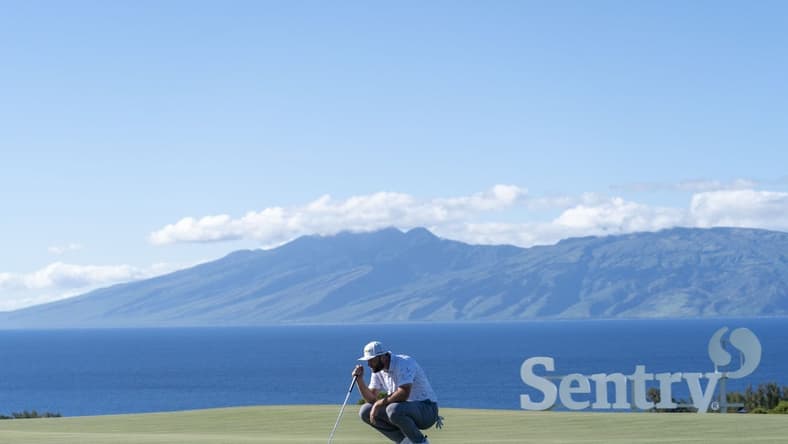 January 8, 2022; Maui, Hawaii, USA; Jon Rahm lines up his putt on the 10th hole during the third round of the Sentry Tournament of Champions golf tournament at Kapalua Resort - The Plantation Course. Mandatory Credit: Kyle Terada-USA TODAY Sports