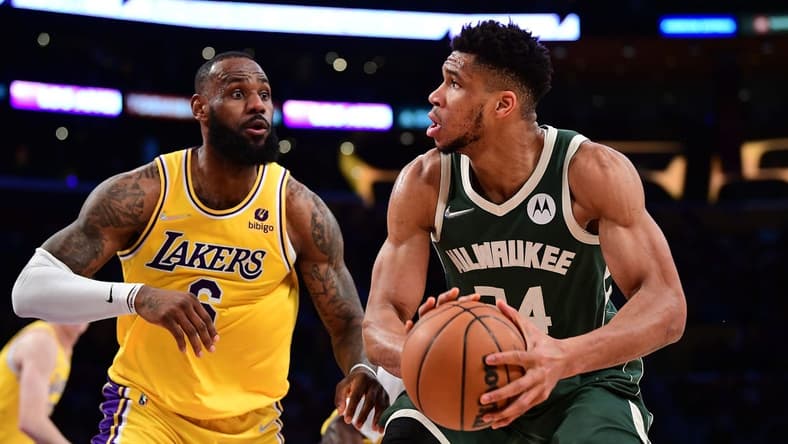 Feb 8, 2022; Los Angeles, California, USA; Milwaukee Bucks forward Giannis Antetokounmpo (34) moves the ball against Los Angeles Lakers forward LeBron James (6) during the second half at Crypto.com Arena. Mandatory Credit: Gary A. Vasquez-USA TODAY Sports