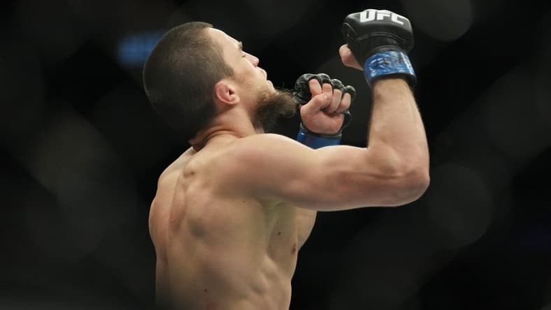 Mar 5, 2022; Las Vegas, Nevada, UNITED STATES; Umar Nurmagomedov (blue gloves) celebrates after defeating Brian Kelleher (not pictured) during UFC 272 at T-Mobile Arena. Mandatory Credit: Stephen R. Sylvanie-USA TODAY Sports