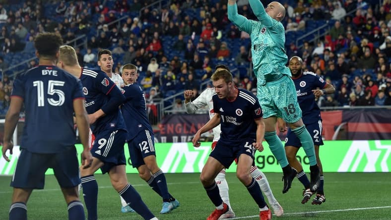 Apr 2, 2022; Foxborough, Massachusetts, USA; New England Revolution goalkeeper Brad Knighton (18) makes a corner kick save during the second half against the New York Red Bulls at Gillette Stadium. Mandatory Credit: Bob DeChiara-USA TODAY Sports