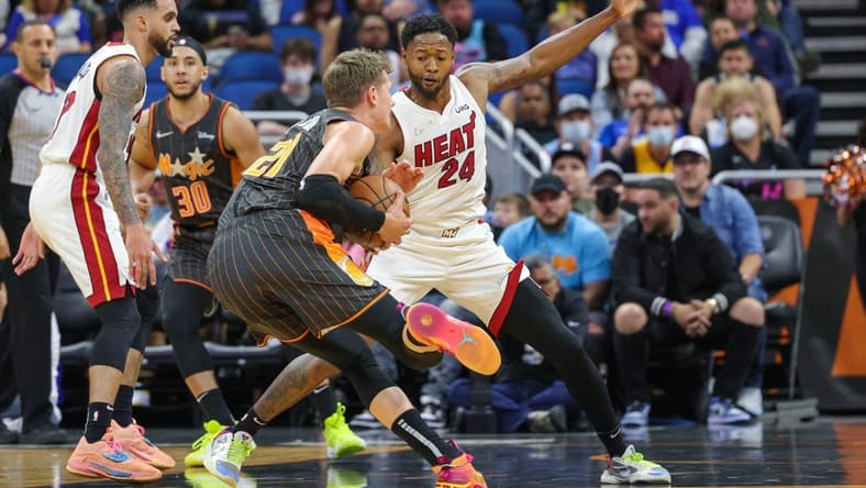 Apr 10, 2022; Orlando, Florida, USA; Miami Heat forward Haywood Highsmith (24) defends Orlando Magic center Moritz Wagner (21) during the first quarter at Amway Center. Mandatory Credit: Mike Watters-USA TODAY Sports
