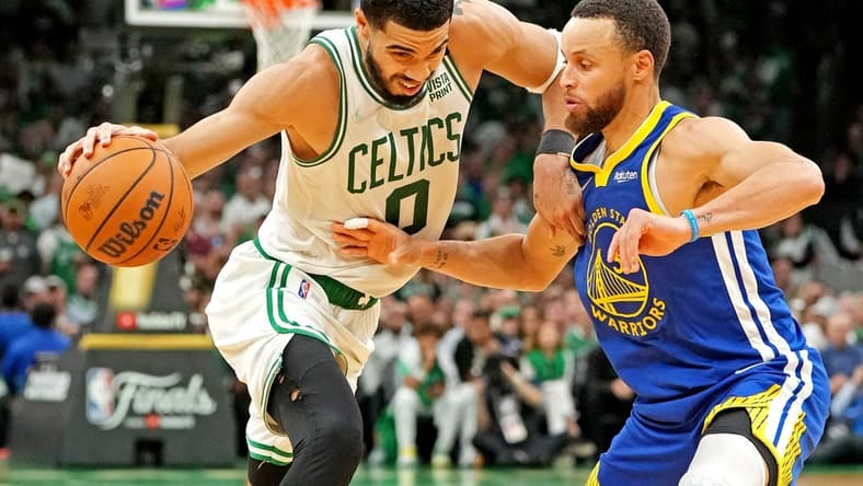 Jun 16, 2022; Boston, Massachusetts, USA; Boston Celtics forward Jayson Tatum (0) handles the ball against Golden State Warriors guard Stephen Curry (30) during the fourth quarter in game six of the 2022 NBA Finals at TD Garden. Mandatory Credit: Kyle Terada-USA TODAY Sports