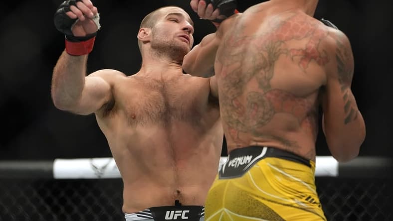 Jul 2, 2022; Las Vegas, Nevada, USA; Sean Strickland (red gloves) and Alex Pereira (blue gloves) fight in a bout during UFC 276 at T-Mobile Arena. Mandatory Credit: Stephen R. Sylvanie-USA TODAY Sports