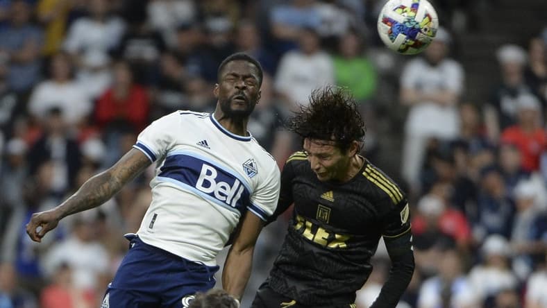Jul 2, 2022; Vancouver, British Columbia, CAN;  Vancouver Whitecaps forward Tosaint Ricketts (87) goes up for a header against Los Angeles FC midfielder Ilie Sanchez (6) during the second half at BC Place. Mandatory Credit: Anne-Marie Sorvin-USA TODAY Sports