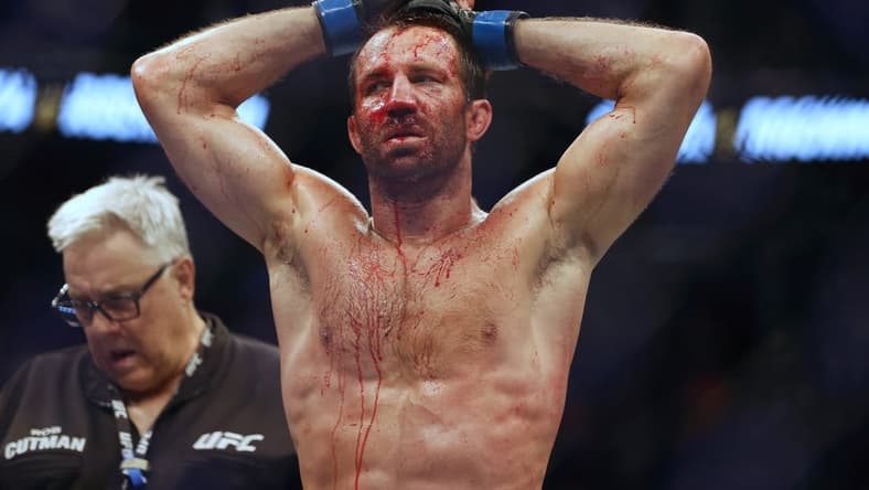 Aug 20, 2022; Salt Lake City, Utah, USA; Luke Rockhold (blue gloves) reacts after being defeated by Paulo Costa (red gloves) during UFC 278 at Vivint Arena. Mandatory Credit: Jeffrey Swinger-USA TODAY Sports