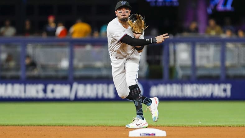 Sep 21, 2022; Miami, Florida, USA; Miami Marlins shortstop Miguel Rojas (11) throws to first base to retire Chicago Cubs second baseman David Bote (not pictured) during the fourth inning at loanDepot Park. Mandatory Credit: Sam Navarro-USA TODAY Sports