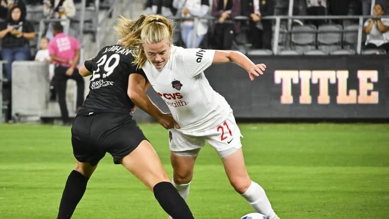 Sep 21, 2022; Los Angeles, California, USA; Washington Spirit midfielder Anna Heilferty (21) and Angel City FC midfielder Clarisse Le Bihan (29) battle for possession during the first half of a NWSL match at Banc of California Stadium. Mandatory Credit: Jayne Kamin-Oncea-USA TODAY Sports