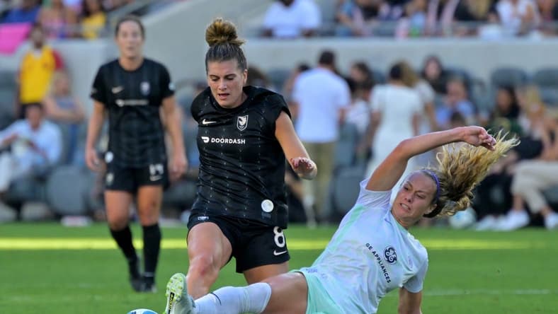 Sep 25, 2022; Los Angeles, California, USA; Racing Louisville FC midfielder Jaelin Howell (6) slide tackles the ball away from Angel City FC midfielder Cari Roccaro (8) during a NWSL game at Banc of California Stadium. Mandatory Credit: Jayne Kamin-Oncea-USA TODAY Sports