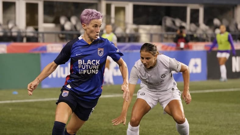 Oct 1, 2022; Seattle, Washington, USA; OL Reign forward Megan Rapinoe (15) controls the ball against Orlando Pride defender Kylie Strom (23)in the first half at Lumen Field. Mandatory Credit: Stephen Brashear-USA TODAY Sports