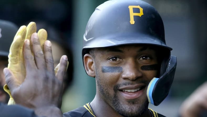 Oct 5, 2022; Pittsburgh, Pennsylvania, USA; Pittsburgh Pirates left fielder Miguel Andujar (26) celebrates in the dugout after scoring against the St. Louis Cardinals during the fourth inning at PNC Park. Mandatory Credit: Charles LeClaire-USA TODAY Sports