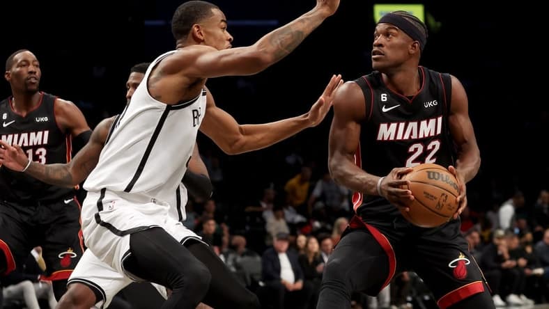 Oct 6, 2022; Brooklyn, New York, USA; Miami Heat forward Jimmy Butler (22) drives to the basket against Brooklyn Nets forward Nic Claxton (33) during the first quarter at Barclays Center. Mandatory Credit: Brad Penner-USA TODAY Sports