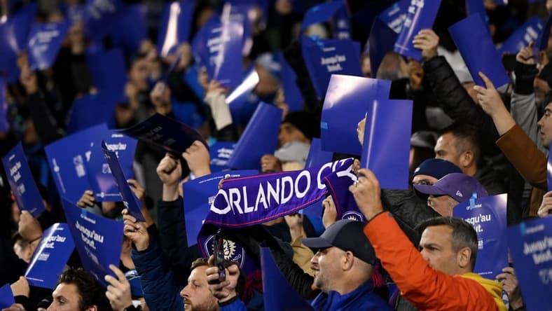 Oct 16, 2022; Montreal, Quebec, Canada; Orlando City fans cheer from the stands during the first half of the match between Orlando City and CF Montreal at Stade Saputo. Mandatory Credit: David Kirouac-USA TODAY Sports
