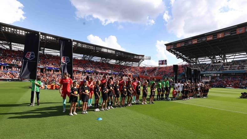 Oct 16, 2022; Houston, Texas, USA; Houston Dash and Kansas City Current line up with the Mastercard kids before the game at PNC Stadium. Mandatory Credit: Troy Taormina-USA TODAY Sports