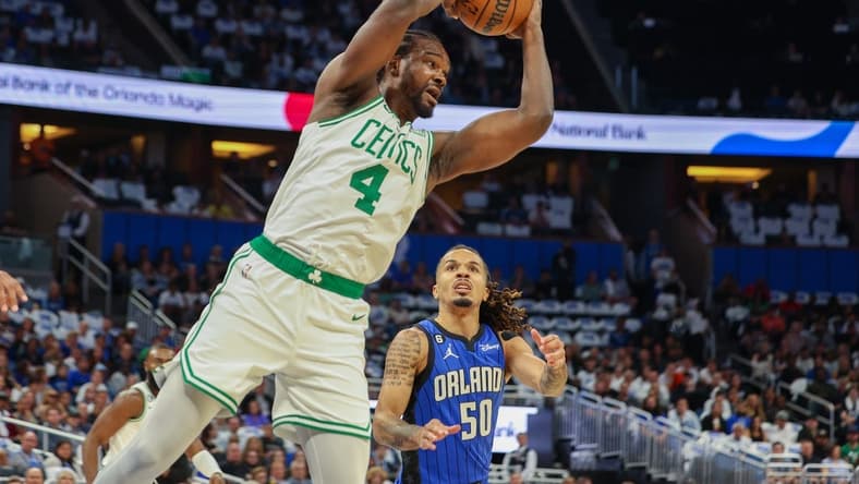 Oct 22, 2022; Orlando, Florida, USA; Boston Celtics forward Noah Vonleh (4) rebounds the ball against the Orlando Magic in the first quarter at Amway Center. Mandatory Credit: Nathan Ray Seebeck-USA TODAY Sports
