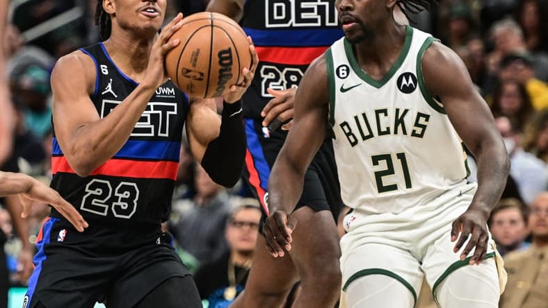 Nov 2, 2022; Milwaukee, Wisconsin, USA; Detroit Pistons guard Jaden Ivey (23) looks for a shot against Milwaukee Bucks guard Jrue Holiday (21) in the fourth quarter at Fiserv Forum. Mandatory Credit: Benny Sieu-USA TODAY Sports