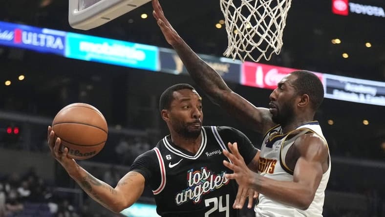 Nov 25, 2022; Los Angeles, California, USA; LA Clippers forward Norman Powell (24) passes the ball against Denver Nuggets guard Davon Reed (9) in the second half at Crypto.com Arena. Mandatory Credit: Kirby Lee-USA TODAY Sports
