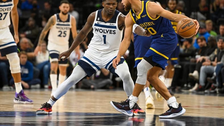 Nov 27, 2022; Minneapolis, Minnesota, USA; Golden State Warriors guard Stephen Curry (30) protects the ball from Minnesota Timberwolves forward Anthony Edwards (1) during the second half at Target Center. Mandatory Credit: Nick Wosika-USA TODAY Sports