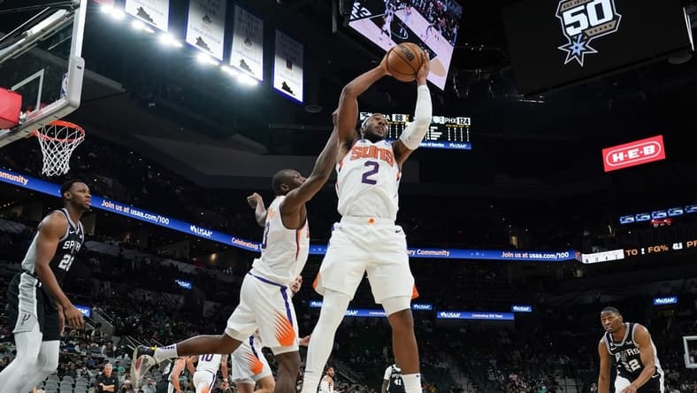 Dec 4, 2022; San Antonio, Texas, USA; Phoenix Suns forward Josh Okogie (2) rebounds in the second half against the San Antonio Spurs at the AT&T Center. Mandatory Credit: Daniel Dunn-USA TODAY Sports