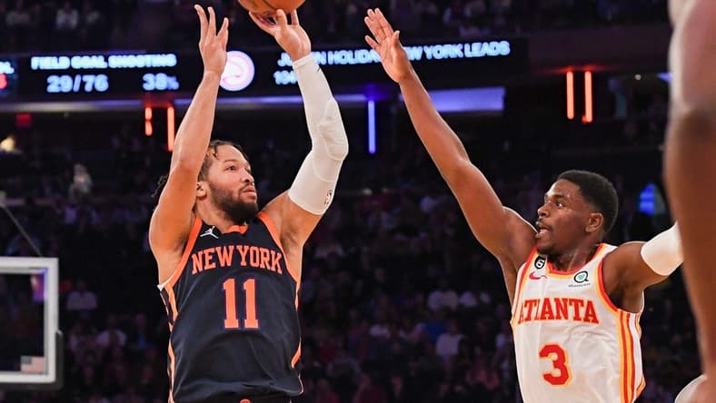 Dec 7, 2022; New York, New York, USA;  New York Knicks guard Jalen Brunson (11) pulls up for a jump shot defended by Atlanta Hawks guard Aaron Holiday (3) during the fourth quarter  at Madison Square Garden. Mandatory Credit: Dennis Schneidler-USA TODAY Sports